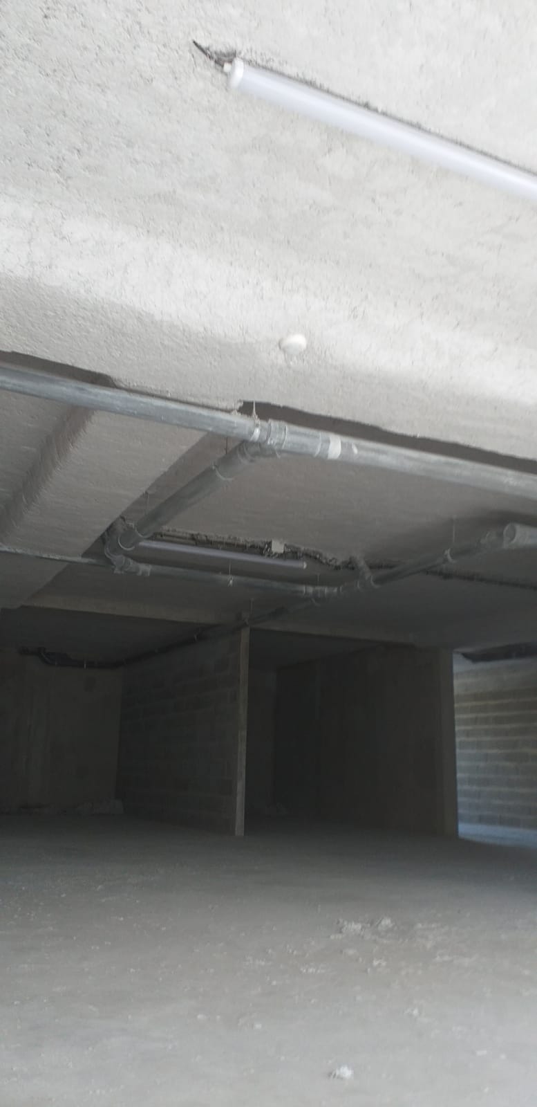 Vue d’ensemble du flocage thermique sous plafond à Lille, avec les réseaux apparents
